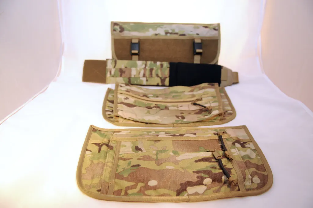 The bag body and three separate Multicam panels and a strap section laid out on a white surface
