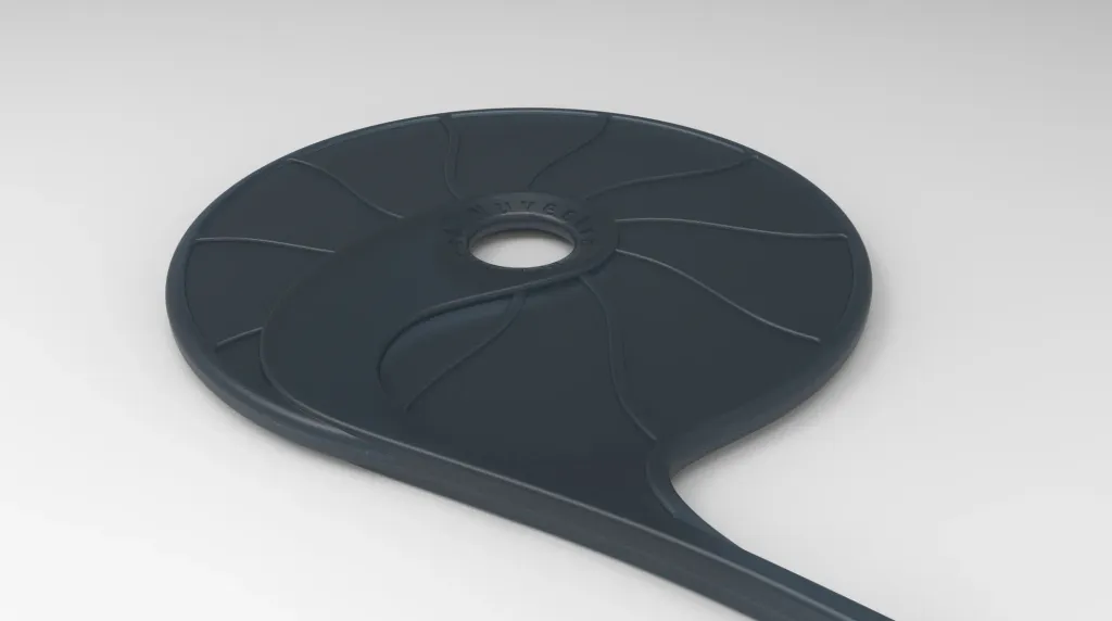 Render of a dark flexible paddle with curved radial ribs, a center opening, and a cable flowing from its edge