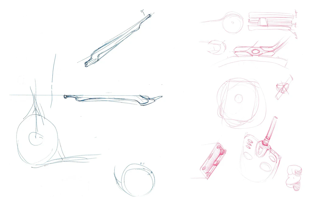 Two sketch pages: blue pen studies of a thin paddle profile and coil outline, and red pen studies of charger and paddle forms