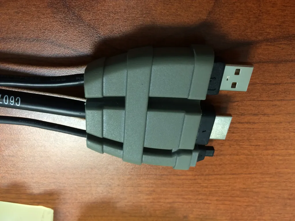 Gray overmolded strain relief holding a cable ending in a USB connector
