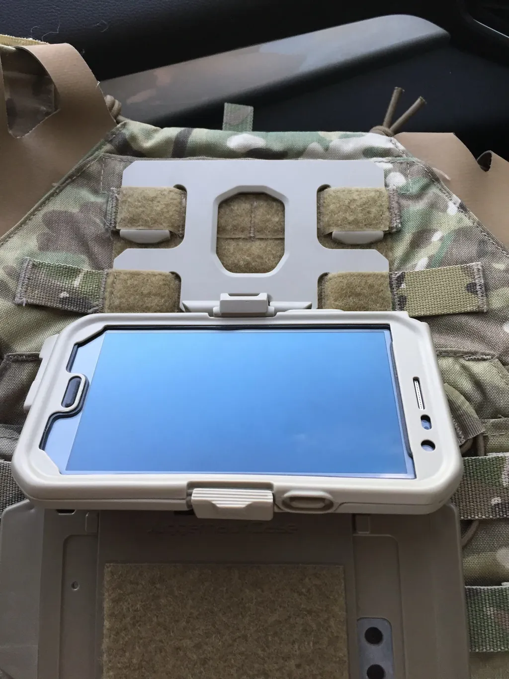 Prototype case folded down against a camouflage plate carrier above a Velcro panel